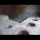 Die Theke in einem antiken Imbiss (Thermopolium) mit den eingelassenen Behältern für Speisen